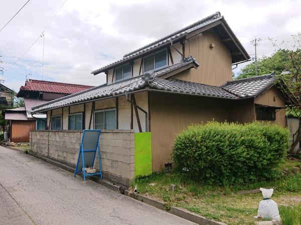 Wooden 2-story house with garden and field